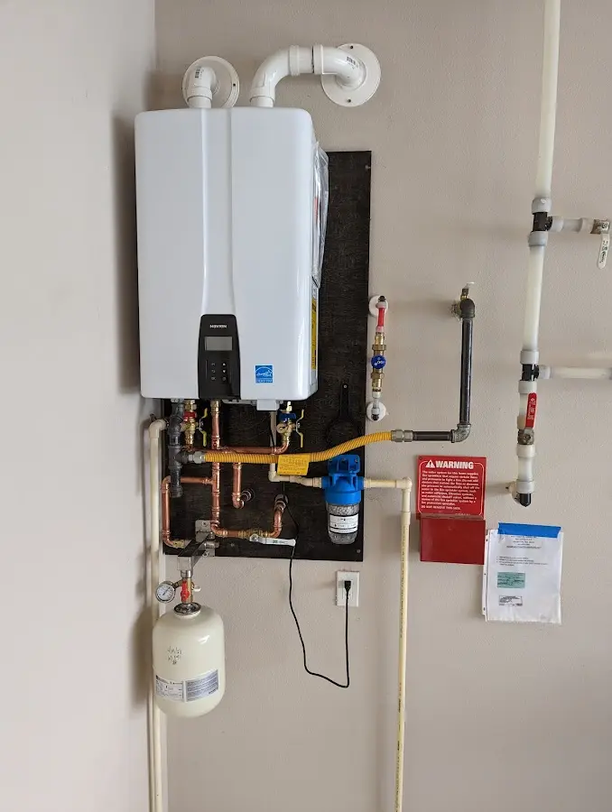 Professional plumber installing copper piping in a Redwood home